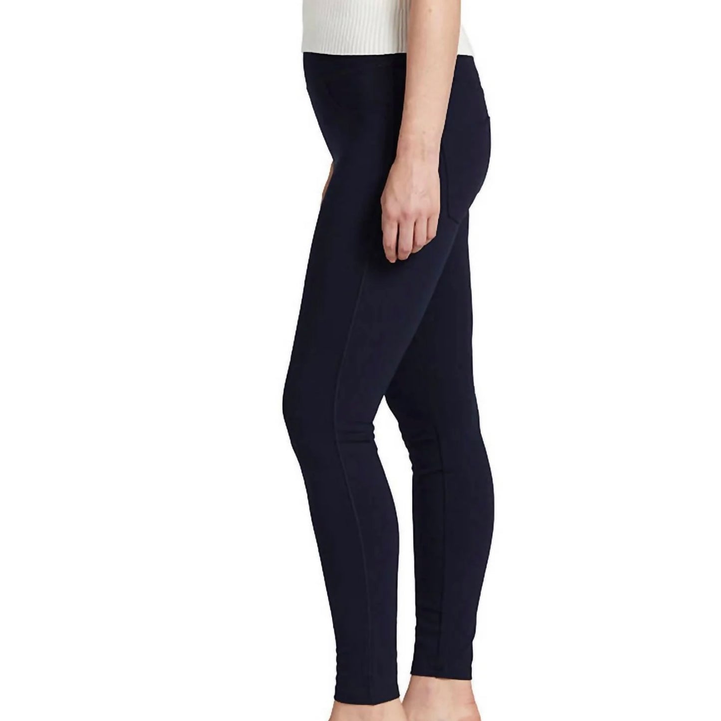 A person is wearing Ricki Mid Rise Leggings in navy by JAG with a white top. The photograph is cropped at the neck and ankles, focusing on the clothing. The background is plain white.