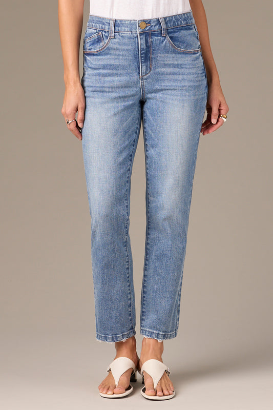 A person wearing Logan Hi-Rise Skinny jeans by Wit & Wisdom in light blue and white sandals stands against a neutral background. The jeans feature a classic five-pocket design, offering a comfortable fit with the hem just above the ankles.