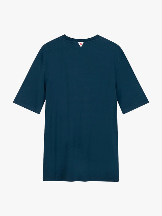 The Toma Tee 2nd Skin - REFLECTING POND, a plain dark blue T-shirt showcased from the back against a white background, features short sleeves and no visible logos or patterns. Crafted from breathable fabric, this essential piece by Once We Were Warriors ensures comfort and style effortlessly.