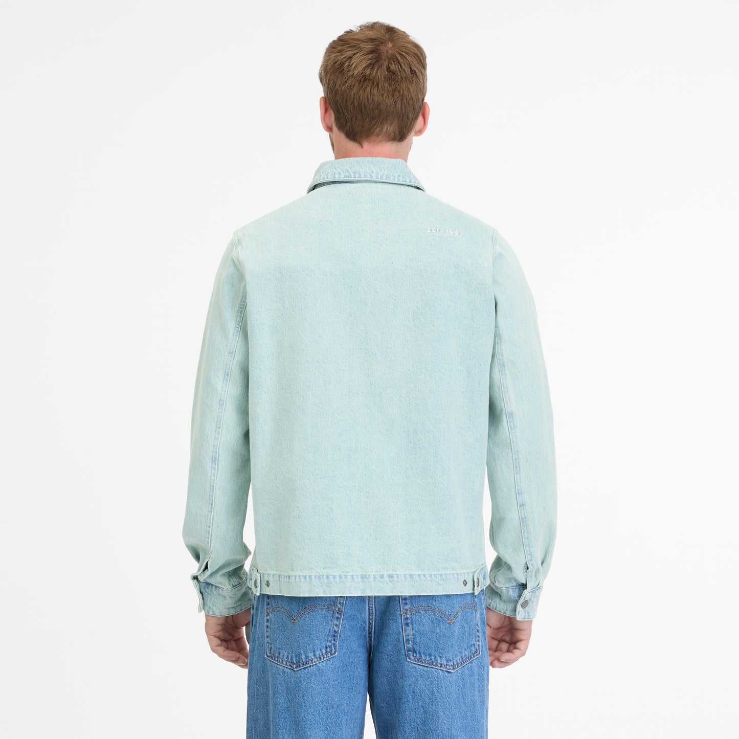 Facing away with short hair, a person wears a light blue CORDYREO DENIM 2512-60004-2042 by RAGWEAR with jeans against a plain white background, enhancing the casual look.