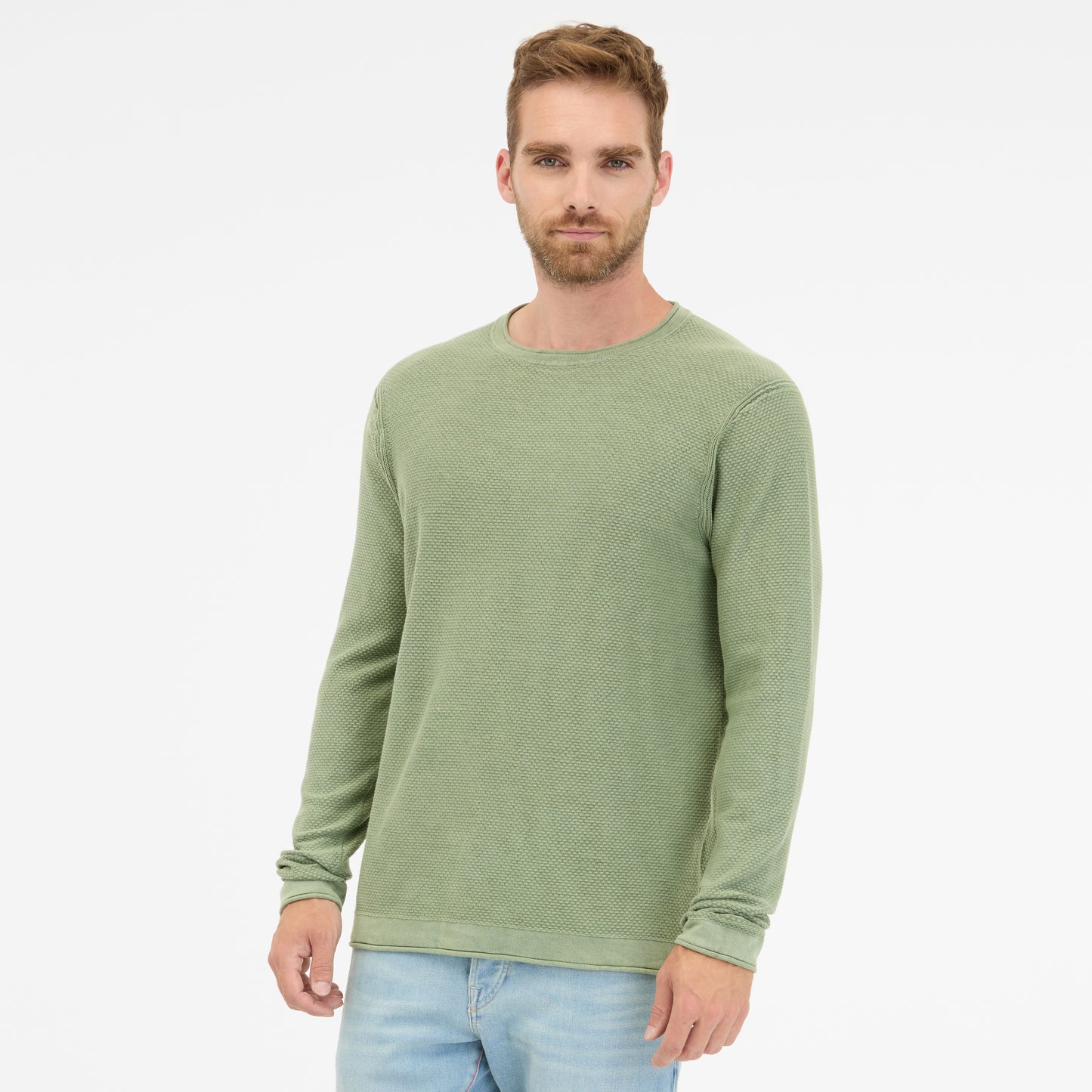 A man with short hair, wearing a TORIEN 2512-35001-5033 RAGWEAR cotton sweatshirt in light green and light blue jeans, stands against a plain white backdrop with a neutral expression facing the camera.