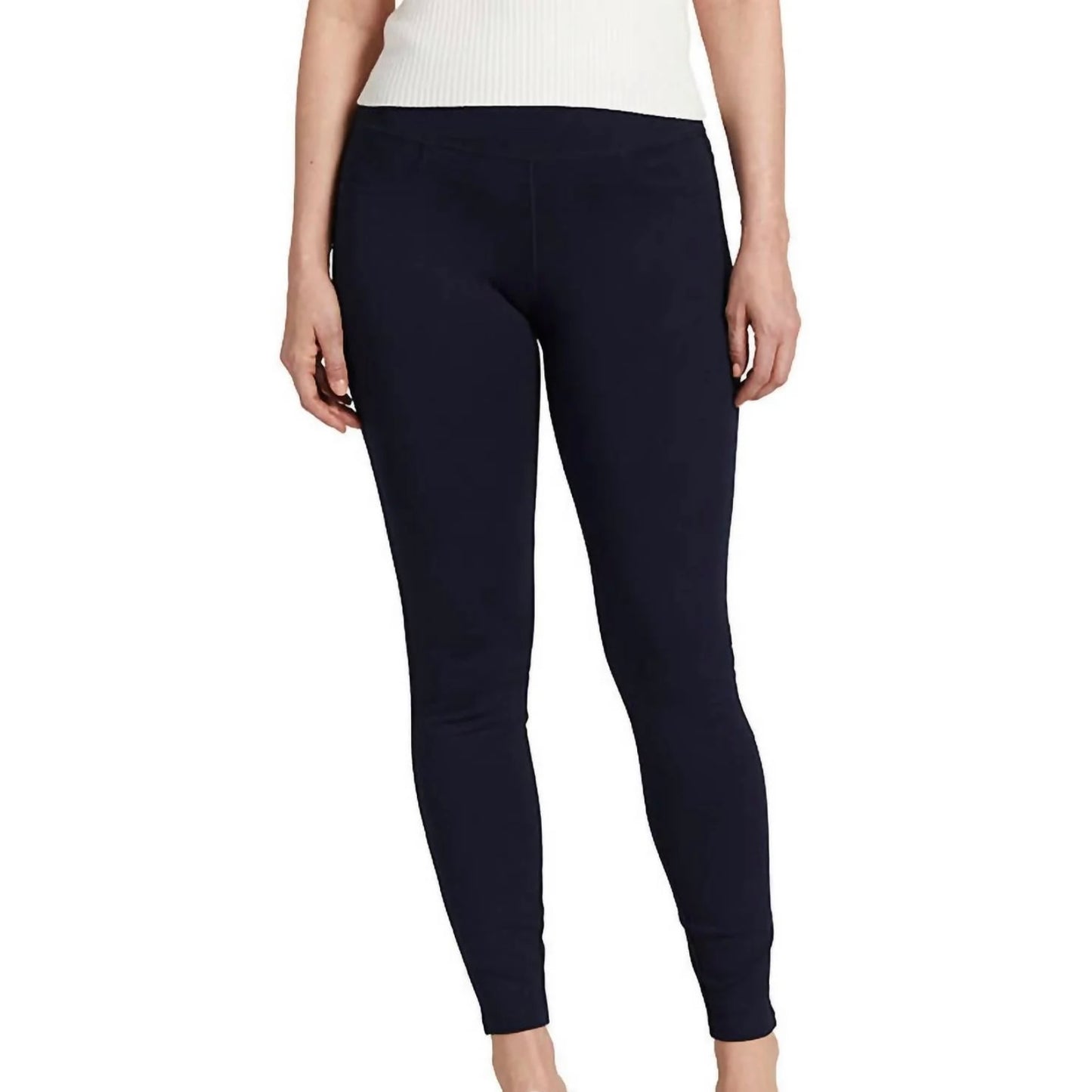A person is wearing Ricki Mid Rise Leggings in navy by JAG with a white top. The photograph is cropped at the neck and ankles, focusing on the clothing. The background is plain white.