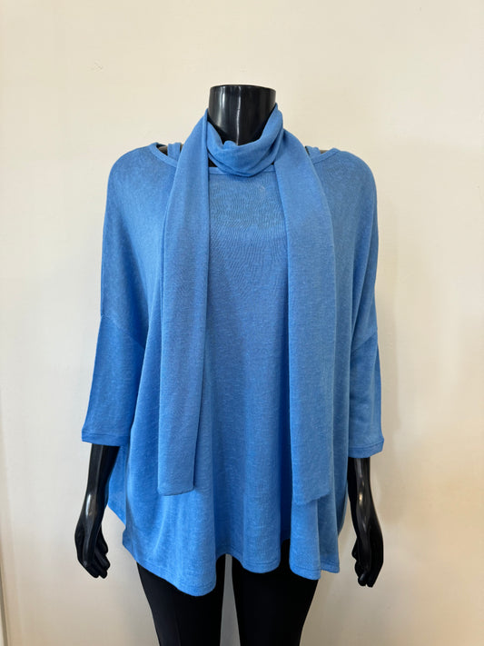 A black mannequin is showcasing a sleeveless, loose-fitting, blue tank top with a scooped neckline. The backdrop features a plain off-white wall. This stylish piece, part of the MARBLE Tank with Cover Top and Scarf set (Product Code: 6551 Marble), boasts thin shoulder straps and a simple, casual design.