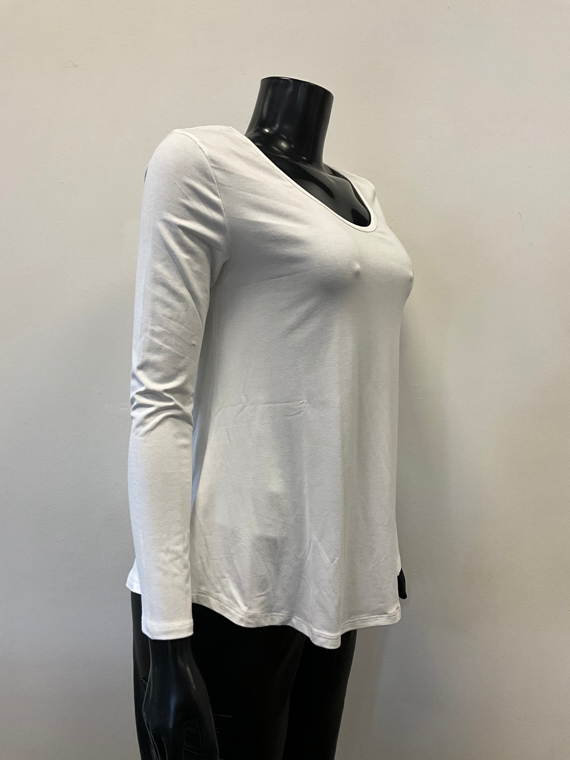 A black mannequin dressed in an ETERNELLE Top Round Neck - Eternelle, a long-sleeved white shirt with a scooped neckline and a slightly flared bottom. The elegant garment, meticulously crafted in Italy, is set against a plain, light-colored background. Only the upper torso of the mannequin is visible, with no accessories in sight.