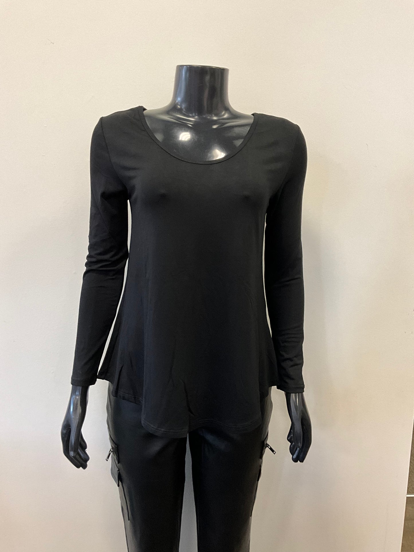 A black mannequin dressed in an ETERNELLE Top Round Neck - Eternelle, a long-sleeved white shirt with a scooped neckline and a slightly flared bottom. The elegant garment, meticulously crafted in Italy, is set against a plain, light-colored background. Only the upper torso of the mannequin is visible, with no accessories in sight.
