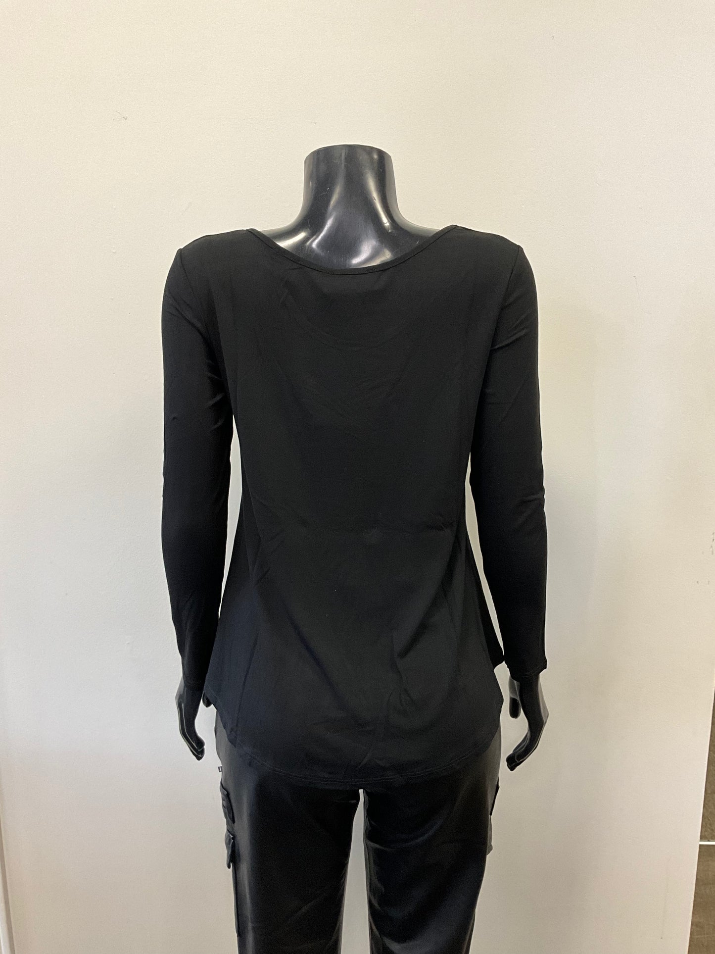 A black mannequin dressed in an ETERNELLE Top Round Neck - Eternelle, a long-sleeved white shirt with a scooped neckline and a slightly flared bottom. The elegant garment, meticulously crafted in Italy, is set against a plain, light-colored background. Only the upper torso of the mannequin is visible, with no accessories in sight.