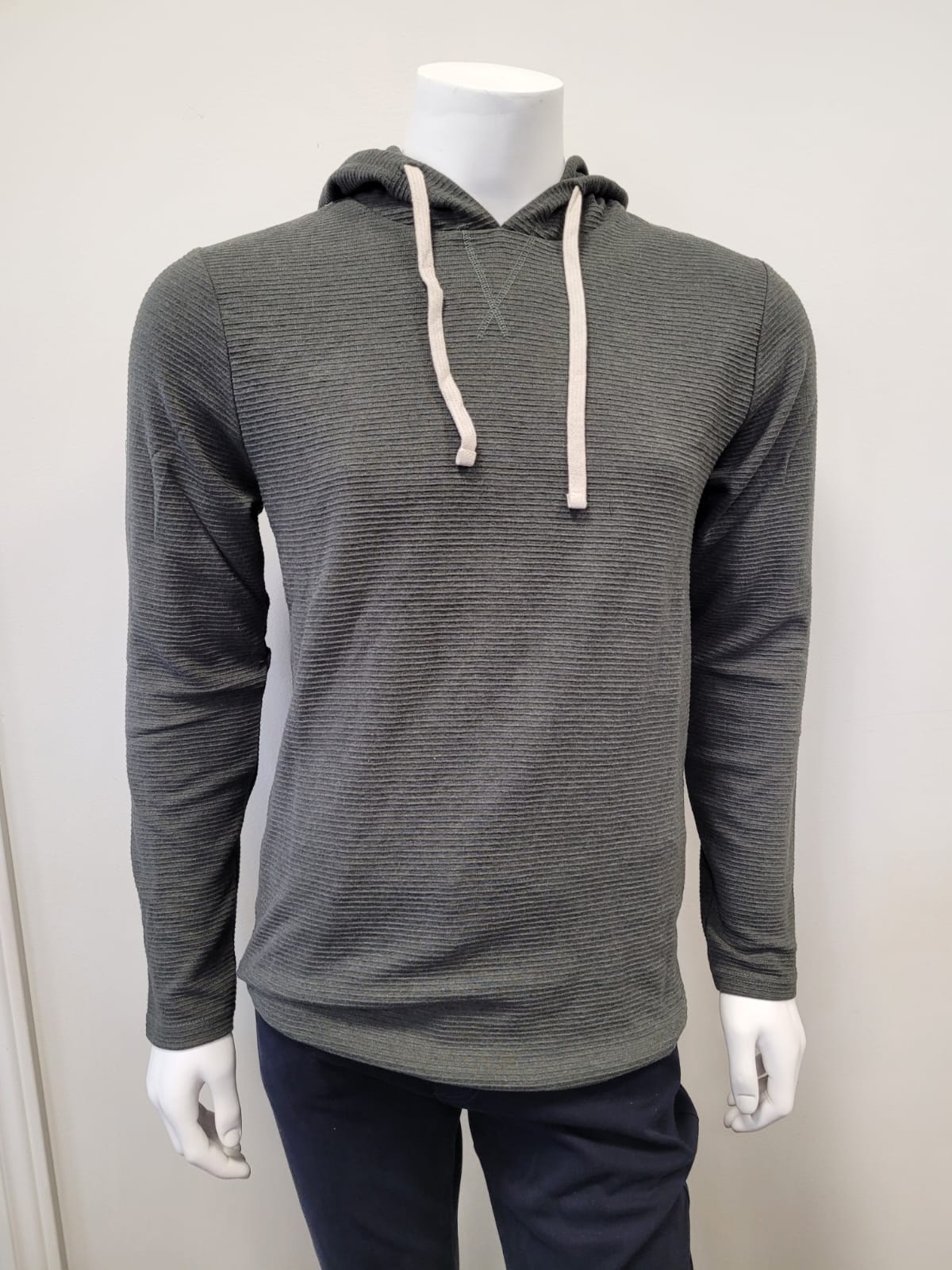 A mannequin wears the HEDGE Oxford Green Men’s Hoodie - Hedge, featuring a textured dark gray look with white drawstrings, and dark pants, posed against a plain white background.