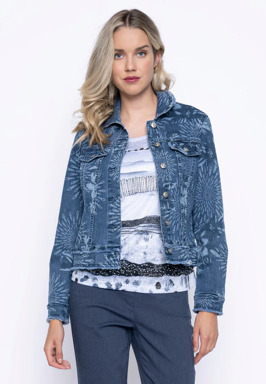 A woman with long blonde hair models a Joseph Ribkoff Printed Denim Jacket G6422GX - PICADILLY, featuring a blue floral pattern and modern design over a printed T-shirt and blue pants against a plain white background.