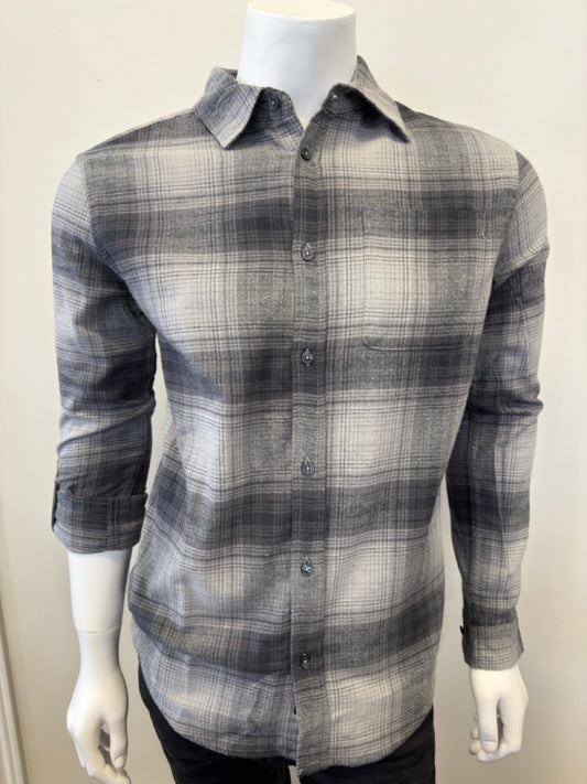 A mannequin dressed in the Silver Jeans Co. Shirt Long Sleeve - GREY, made from 100% cotton and featuring a button-down plaid pattern in shades of black, gray, and white. The shirt includes a collar and a single chest pocket. The mannequin's arms are positioned straight down as it stands against a plain white background.