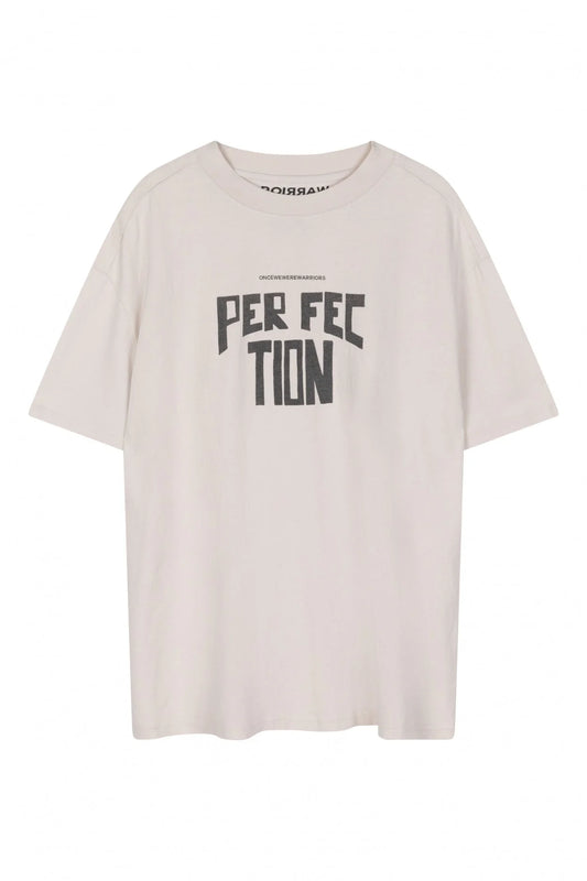 The Talan Tee - WHITE SAND by Once We Were Warriors is a simple, light-colored t-shirt crafted from 100% cotton, featuring the word "PERFECTION" in bold, black letters on the front. The slightly arched text highlights the middle letters. Ideal for everyday wear, this short-sleeved t-shirt drapes effortlessly against a plain background.