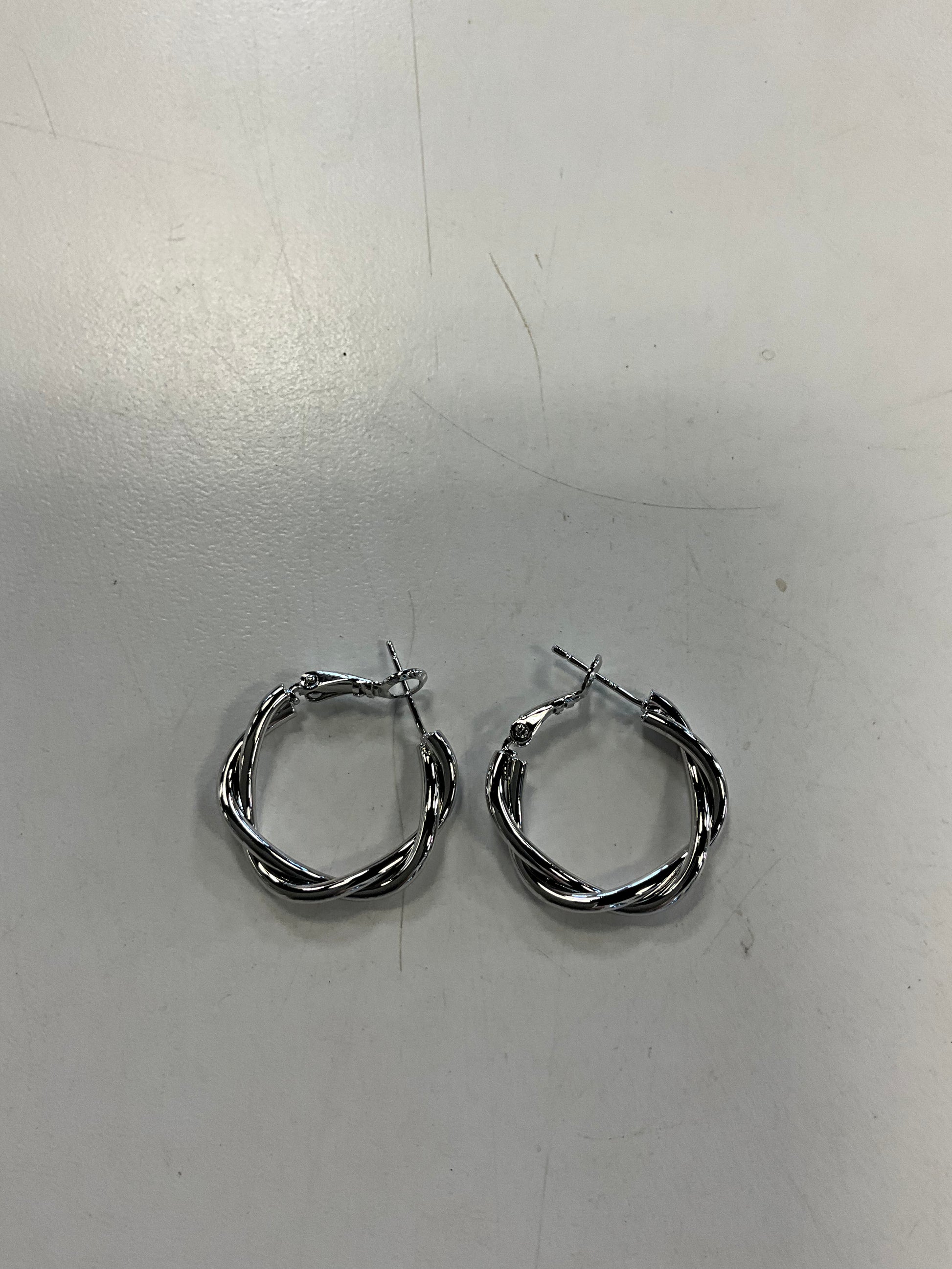 The Sky 1 Silver Hoop Earrings by Elise Accessories are small, twisted silver hoops with latch clasps—perfect as an elegant addition to your costume jewellery collection.