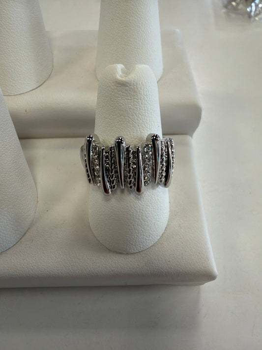 Jenna 91 Ring featuring a silver abstract bar design with vertical metallic prongs alternating with rows of small clear CZ stones.
