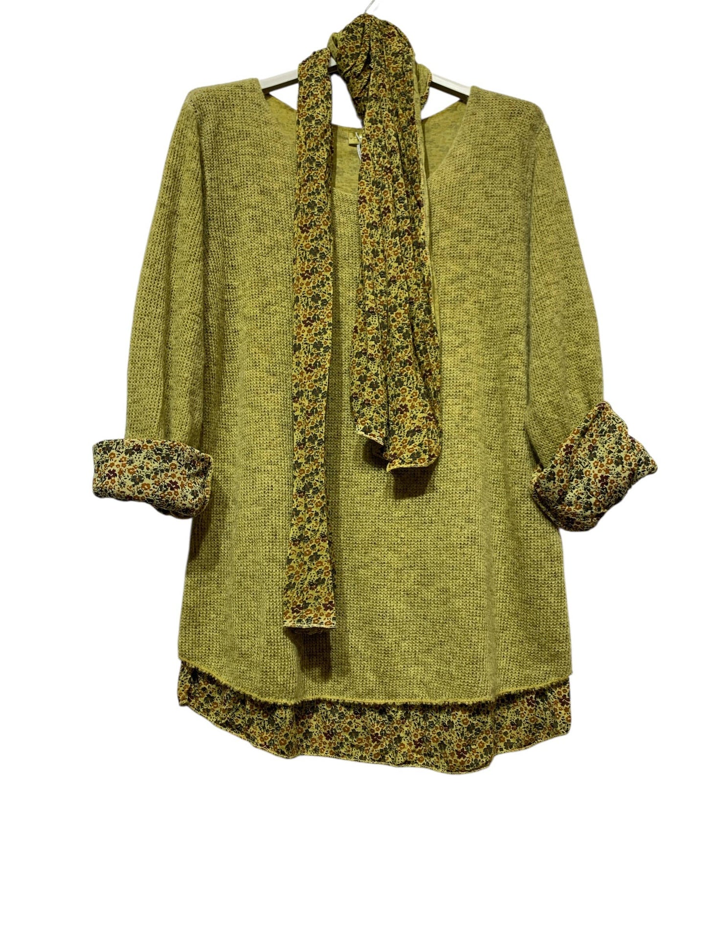 The LINEN & COTTON HOUSE “Tunic with scarf 1111 VINTAGE: OLIVE” features a light olive-green long-sleeve tunic adorned with vintage-inspired floral accents on the cuffs and hem, complemented by a matching floral scarf. Both pieces are tastefully showcased on a hanger against a white background.
