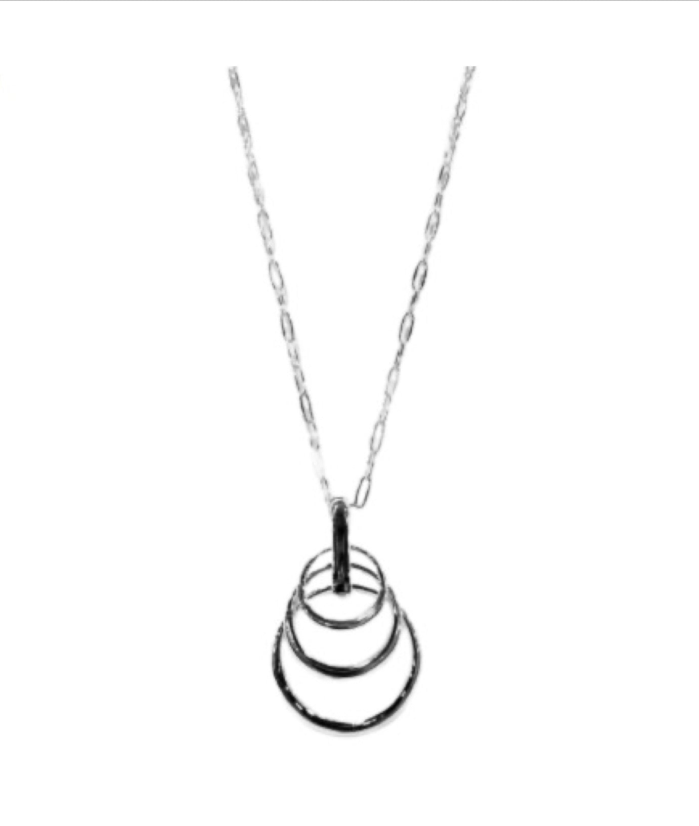 The Ava 3 Silver Necklace by Elise accessories features a delicate chain with four interlocking rings in descending sizes, offering a minimalist, modern twist on classic costume jewellery, shown against a plain white background.
