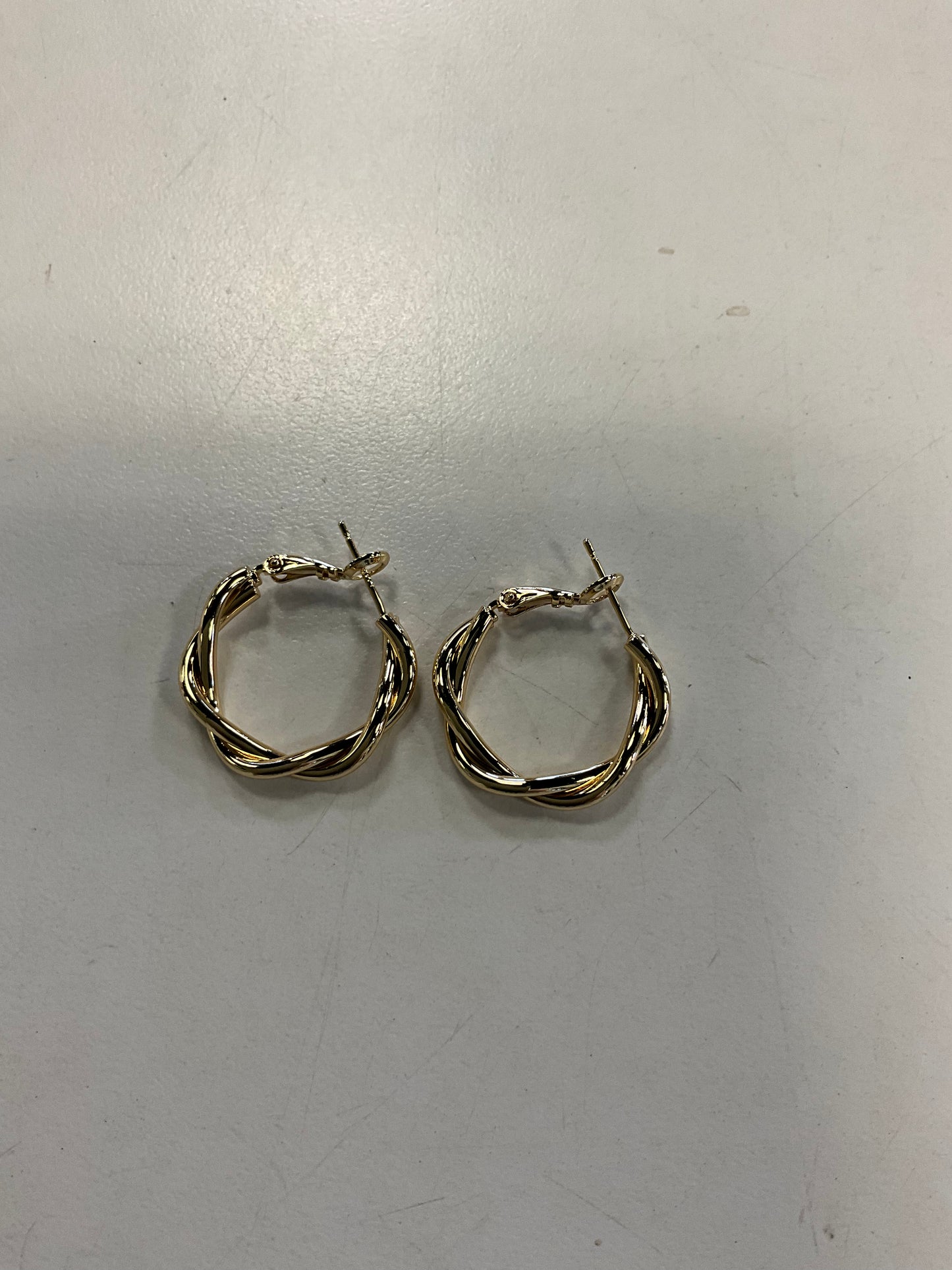 Sky 1 Gold Hoop Earrings by Elise Accessories—small, gold twisted hoops with secure lever back closures, displayed on a plain white surface; a timeless piece for any costume jewellery collection.