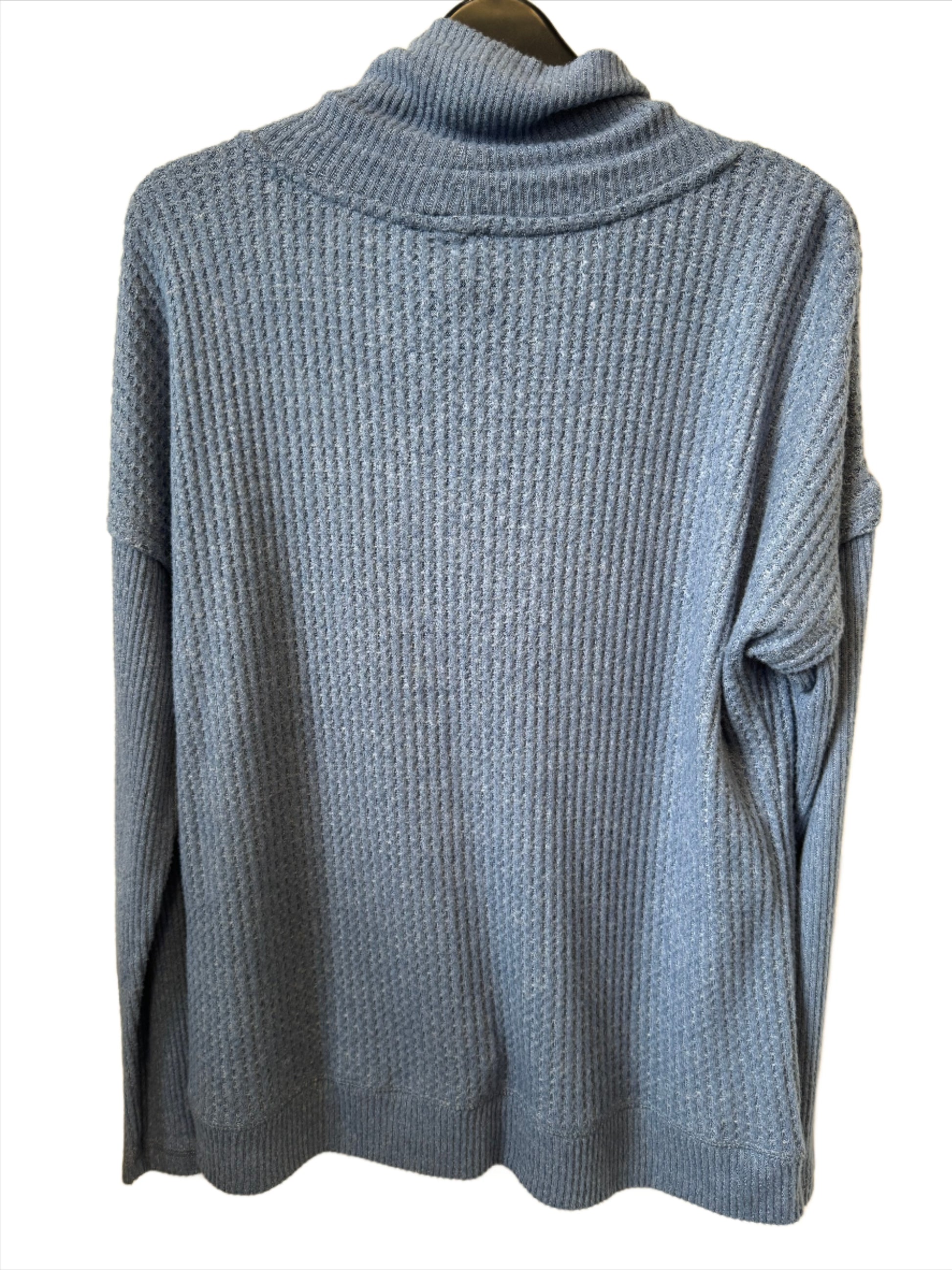 A cozy, arctic blue cowl neck sweater with long sleeves, ribbed texture, and white drawstrings from the brand Tribal. The Cawl Neck Sweater - TRIBAL is displayed on a black hanger labeled "Bali.