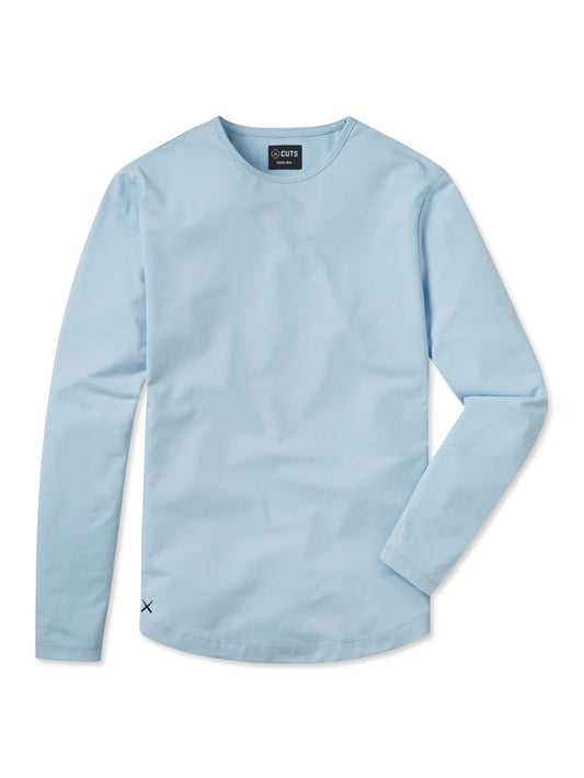 A light blue AO Long Sleeve Curve-Hem Tee by CUTS showcases a simple and clean design. This Signature-fit piece features a small black tag with white text near the neckline inside the back, and a small black X logo stitched near the bottom left side. Made from PYCA Pro fabric, it feels soft and smooth to the touch.