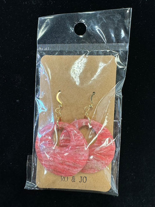 A pair of pink and white striped hoop earrings with gold hooks is enclosed in a clear plastic bag. The brown cardboard backing for display and hanging features the brand name "RO&JO" printed at the bottom, reflecting the charm of artisan craftsmanship. These are listed under product name Ro&Jo Earrings 437.