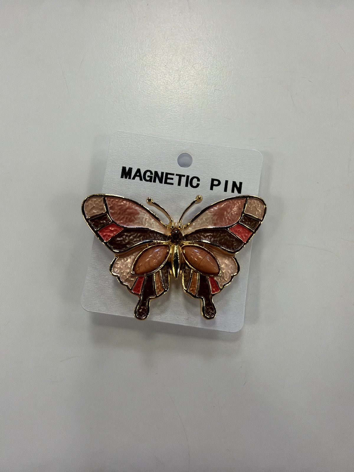 Denise 15 Brooch by Elise accessories, a butterfly-shaped magnetic brooch with gold trim and pink, brown, and orange enamel inlay on a display card.