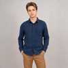 A young man with light brown hair wears the HEDGE Gauze Long Sleeve Shirt Navy (56MW102S) and tan pants, standing with hands in pockets against a plain light gray background—ideal for your summer wardrobe.