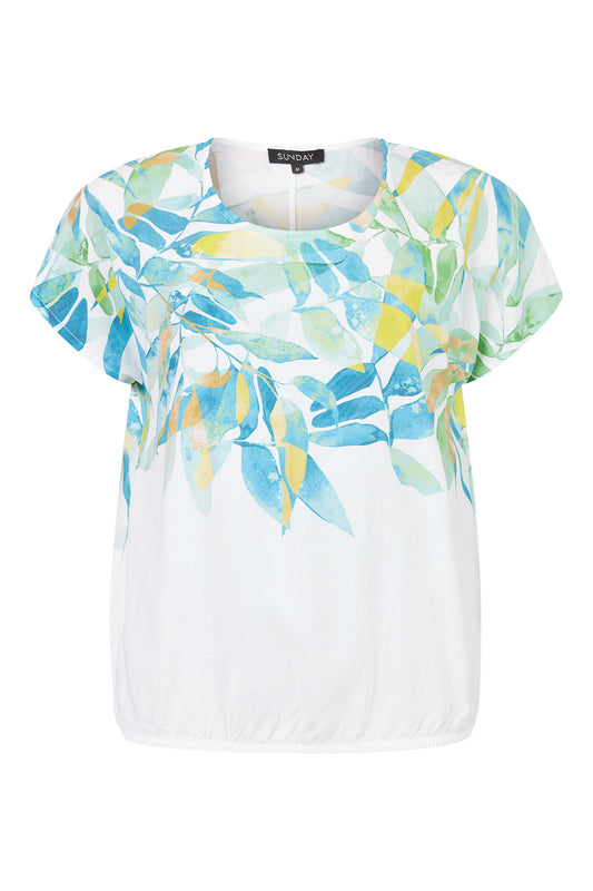 Meet the versatile Top 6425 by SUNDAY: A short-sleeved white blouse featuring a round neckline with a colorful leaf pattern in blue, green, and yellow on the top half. Its slightly elasticated bottom hem ensures a comfortable fit for any weekend outing.