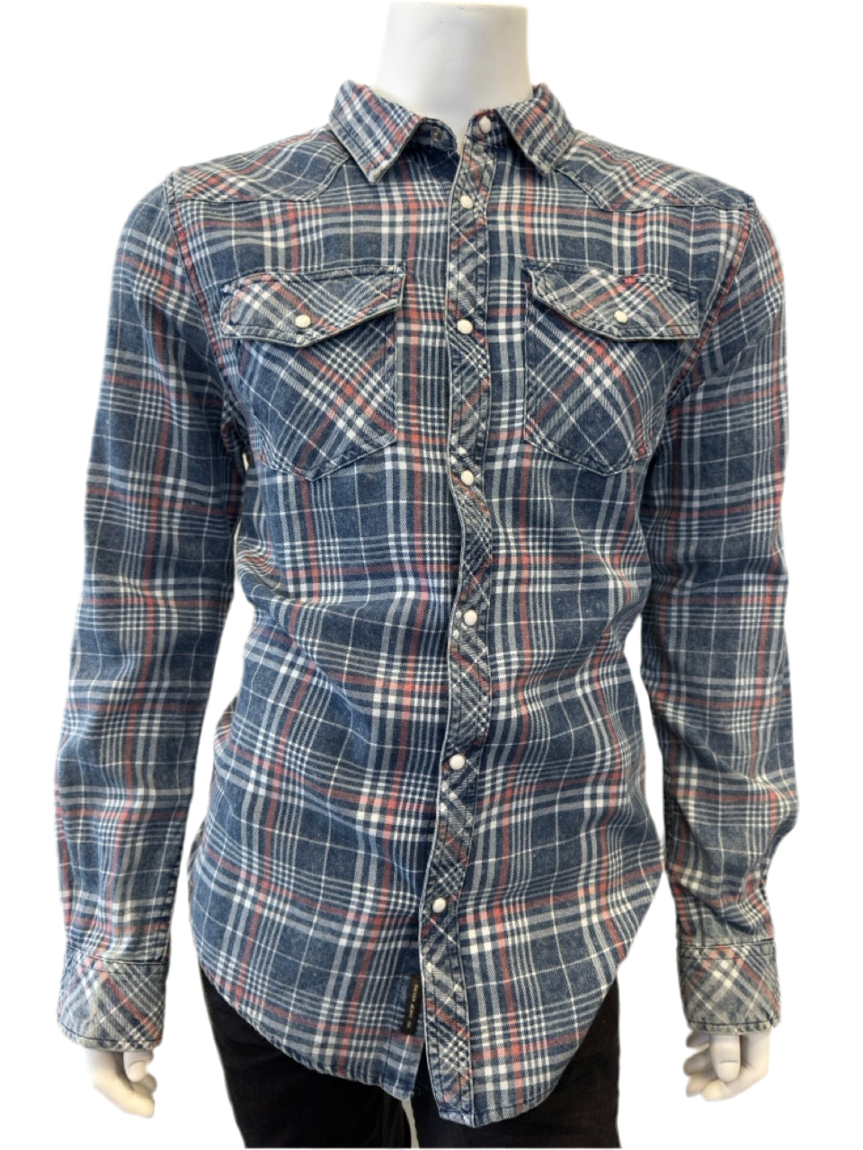 A mannequin is dressed in the Shirt Long Sleeve - BLUE by Silver Jeans Co., featuring a blue, red, and white plaid pattern. The 100% cotton shirt includes two chest pockets with button closures.