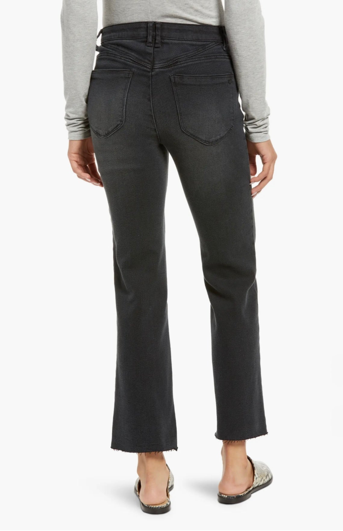 A person wearing a light gray long-sleeve shirt, black high-waisted Bennet Skyrise Jeans L2269E4D4 from Wit & Wisdom at Nordstrom, and slip-on shoes with a snakeskin pattern. The image is cropped just above the person's shoulders.