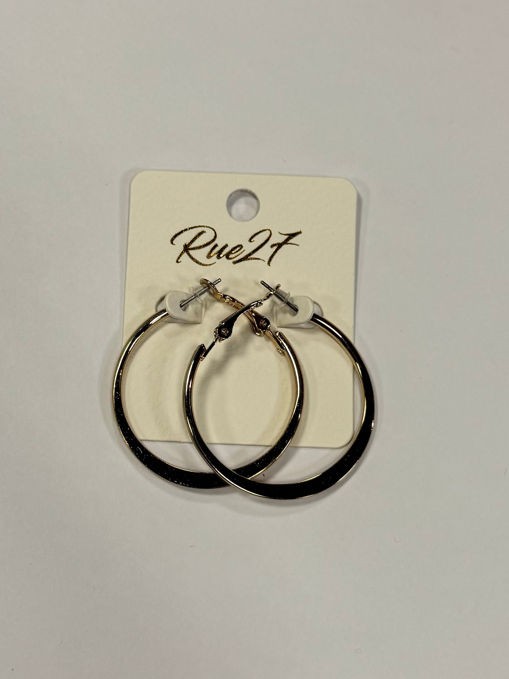 A pair of silver hoop earrings featuring a unique loop design exudes elegance on a display card labeled "Dana 66 Earrings - Elise Accessories" from Posies Flowers & Fashion Inc., set against a plain white background.