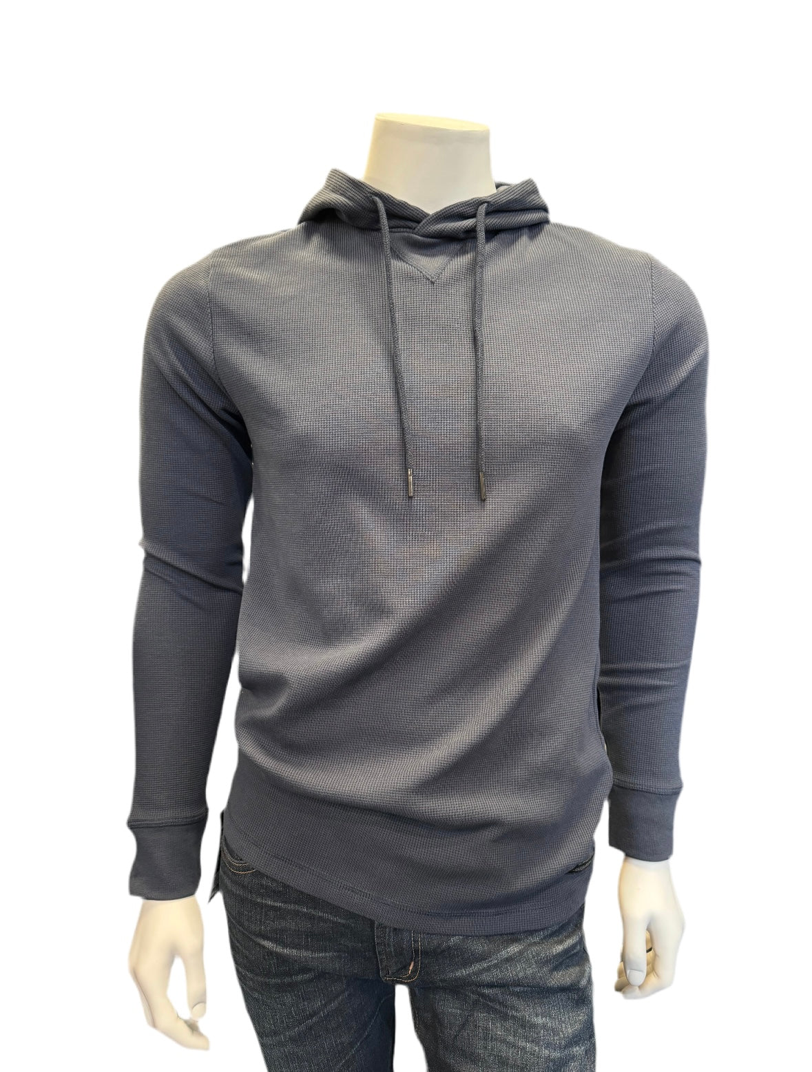 A mannequin dressed in a long-sleeve, navy blue Hoodie Knit from Silver Jeans Co., featuring a drawstring and ribbed texture. The knit fabric blend adds an extra touch of comfort. The mannequin is also wearing dark blue jeans, with the focus on the upper half of the outfit against a plain white background.