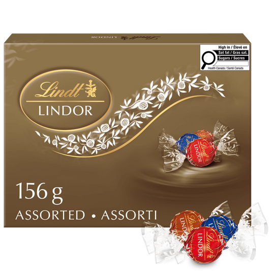 A Lindt Lindor LINDOR Assorted Milk and Dark Chocolate Truffles Box, 156g, is shown with milk and dark truffles on the packaging. Three individually wrapped truffles are placed in front of the box.