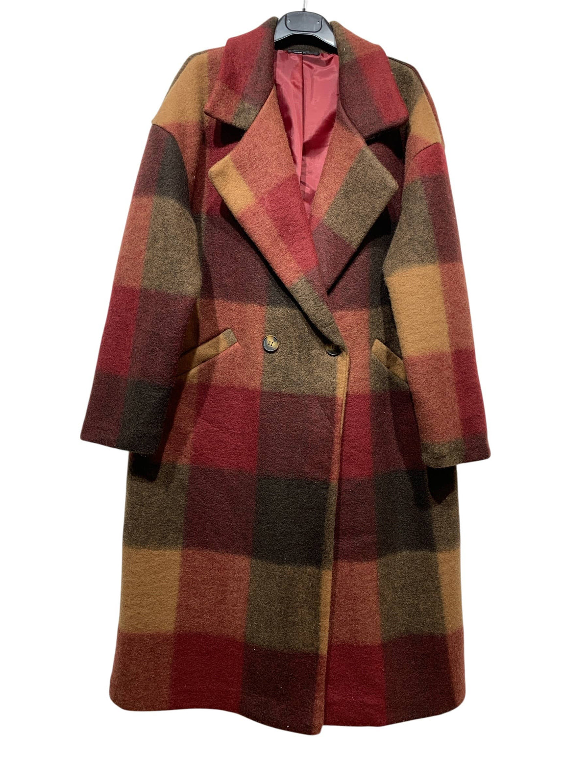 Introducing the 50706 FALL WINTER CLOTHING COAT in Bordeaux by LINEN & COTTON HOUSE—a long wool blend coat showcasing a bold large plaid pattern in striking red, brown, yellow, and orange tones. Thoughtfully designed with wide lapels, two side pockets, a single button closure, and finished with a pinkish inner lining, this coat offers both warmth and standout style for your fall-winter wardrobe.