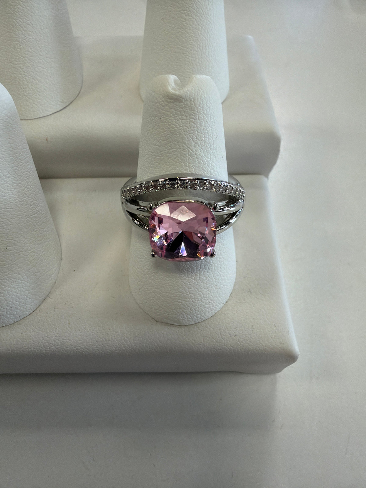 Jenna 96 Ring in silver, featuring a large, square-cut pink gemstone on a stretch band accented with small white stones.