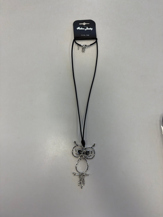 A whimsical silver owl-shaped Sofia 49 Necklace on a long black cord.