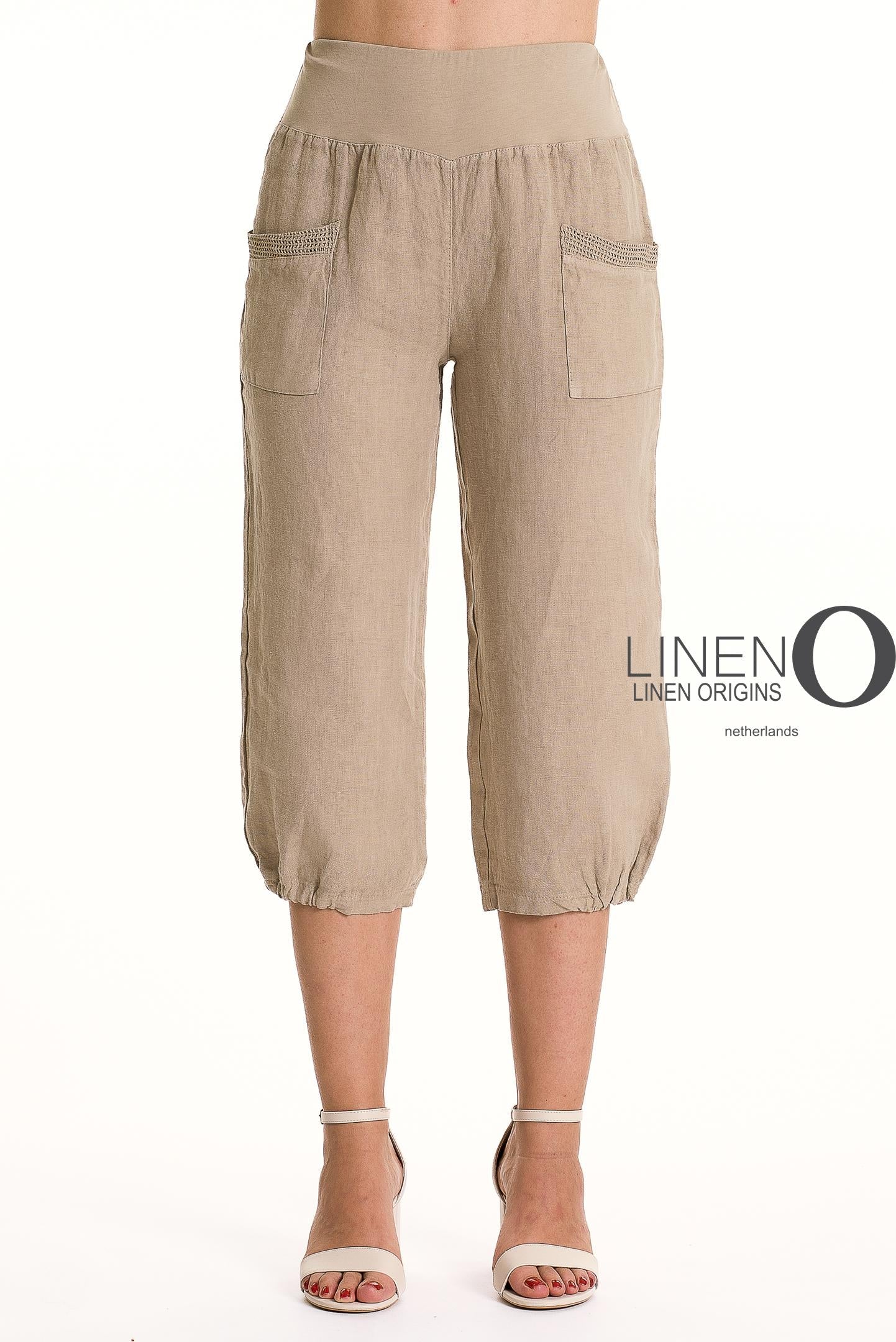 A person wears LinenO’s French Linen Capri PT878-148 Natural, featuring front pockets and an elastic waistband, styled with white open-toe sandals. A white background shows the “Linen O” logo on the right.