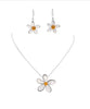 The Nicole 43 WHT Necklace & Earring Set by Elise Accessories features elegant silver costume jewelry with delicate white petals, yellow centers, and a standout larger pendant for extra charm.