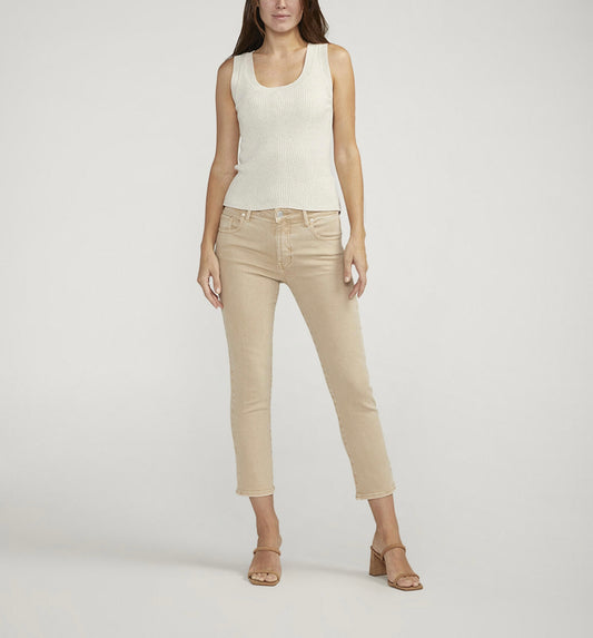 A person stands wearing a sleeveless, cream-colored ribbed top paired with JAG's Cassie Mid Rise Cropped Pants in beige. They are also wearing beige open-toe heels. The background is plain white, and the person's hands rest beside their hips.