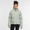 A person with curly hair tied up is wearing a light gray Briony Puffer Jacket 2421-60020 from RAGWEAR, featuring a hood, front zipper, and drawstrings at the waist. Made from vegan materials, it’s both water and windproof. They are also wearing black pants and standing against a plain white background.