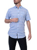 A person is wearing a Men’s Shirt Short Sleeve- BLUE STRIPE and black pants from Silver Jeans Co. The person is facing slightly left, with their right hand holding the summer shirt near the buttons and their left hand resting near their hip.