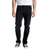 A person wearing a pair of Machray Athletic Fit Straight Leg Silver Jeans M63410CBB532 from Silver Jeans Co. and black sneakers with white laces. The individual is also dressed in a white t-shirt, and the image shows them from the shoulders down, standing against a white background.