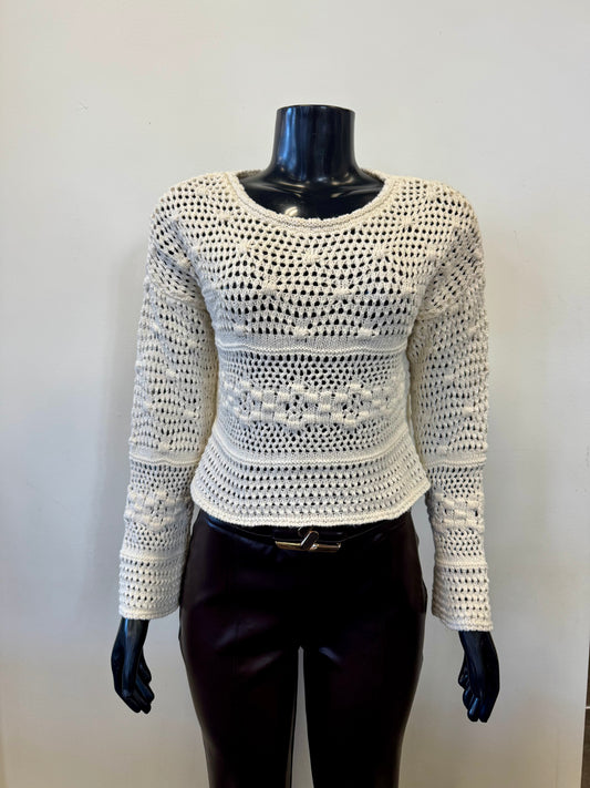 A mannequin displays the Parkhurst Shorty Eco Top 75295, a cream crochet-knit long-sleeve sweater with a round neckline and intricate open-weave pattern, paired with dark brown pants and a simple belt against a plain white background, symbolizing eco-friendly fashion.