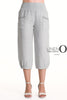 A person wears LinenO's French Linen Capri PT878-152 in Grigio Chiaro with elastic waist and cuffs, front pockets, and pairs them with light gray heeled sandals. The "Linen Origins Netherlands" logo is visible.