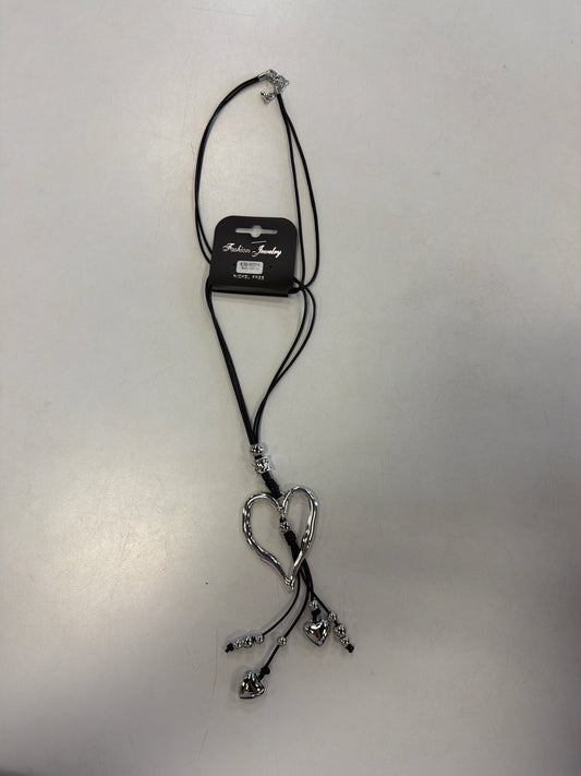 Sofia 41 necklace featuring a long black cord, a large open-heart pendant, and dangling silver-tone heart charms.