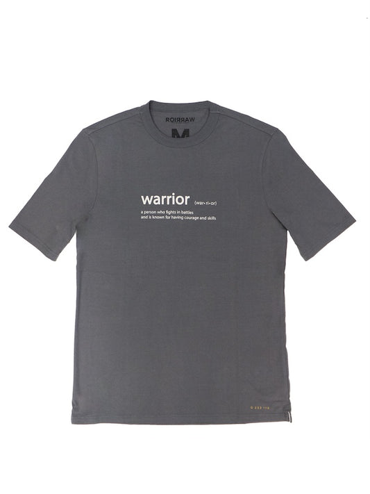 Gray t-shirt with short sleeves. The word "warrior" is printed in white text on the front, followed by its definition: "a person who fights in battles and is known for having courage and skills." The brand name, Once We Were Warriors, is visible on the inside neck label. Inspired by CITY SKYLINE, this Ataja Tee - CITY SKYLINE design stands out.