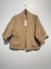 The NOELINE Quilted Jacket 2442-2 in Camel, featuring a tan quilted cotton design with wide sleeves, an oversized fit, and rounded pockets, hangs on a hanger against a plain white wall.