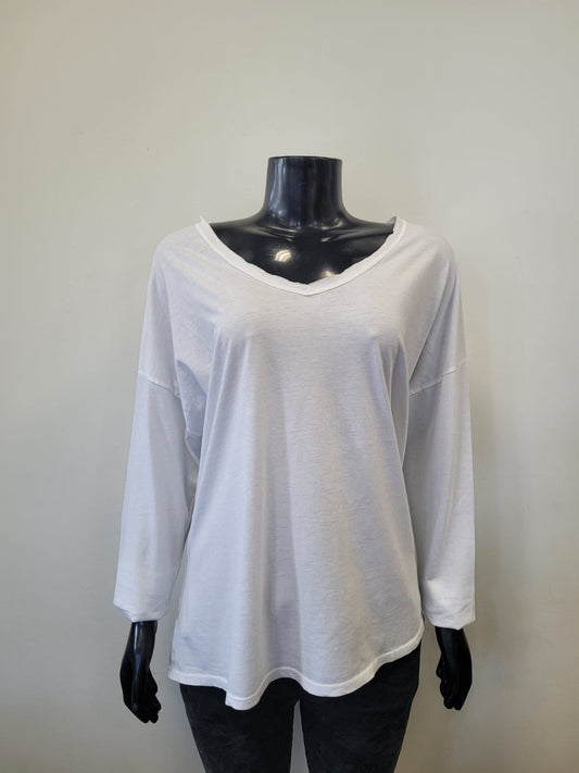 A black mannequin showcases the ETERNELLE V-Neck Long Sleeve Shirt -eternelle, a loose-fitting white cotton top, against a plain light gray background.