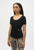 A woman with long hair wears a Joseph Ribkoff Silky Knit Fitted Top With Buckle Detail 252230, paired with leopard print pants. She accessorizes with gold dangling earrings and bracelets, standing against a plain background.