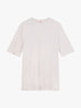 The Toma Tee 2nd Skin in WHITE SAND from Once We Were Warriors is showcased on a white background. This short-sleeve T-shirt features a round neck and a minimalistic design, with no visible logos or patterns. Crafted from stretchy and breathable fabric, it includes only a small red tag at the back neckline.