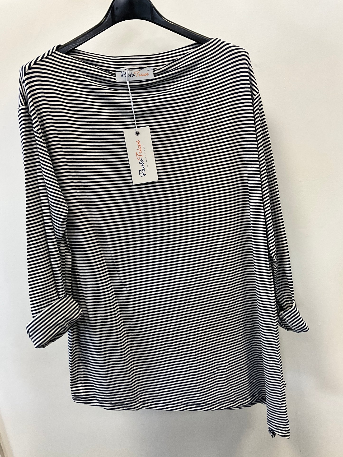 The Paolo Tricot Top DV11971A Navy hangs on a black plastic hanger against a white wall. This lightweight summer top, in nautical stripes, features rolled-up sleeves and has a tag attached to the collar.