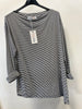 The Paolo Tricot Top DV11971A Navy hangs on a black plastic hanger against a white wall. This lightweight summer top, in nautical stripes, features rolled-up sleeves and has a tag attached to the collar.
