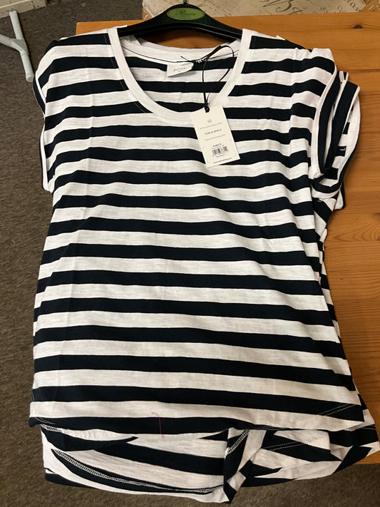 The Role Model Tee Bold Stripe FO8173 by FOIL is a black and white, horizontally striped cotton tee with a price tag, shown on a wooden surface with a black hanger, offering bold stripes for classic nautical style.